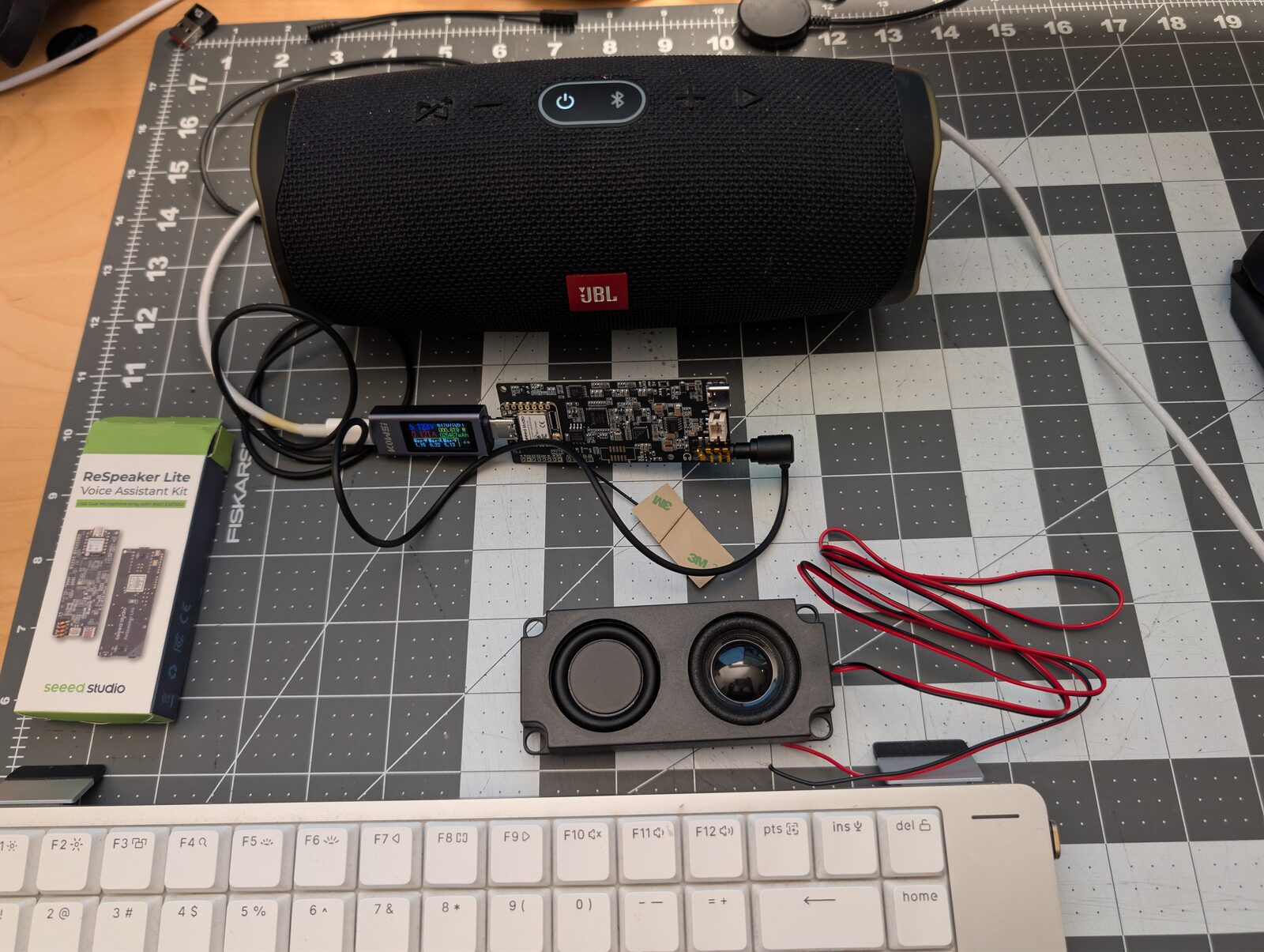 The finished build: a Seeed ReSpeaker Lite board wired into a JBL Charge 4 speaker over a 3.5 mm cable, generating noise on-device.